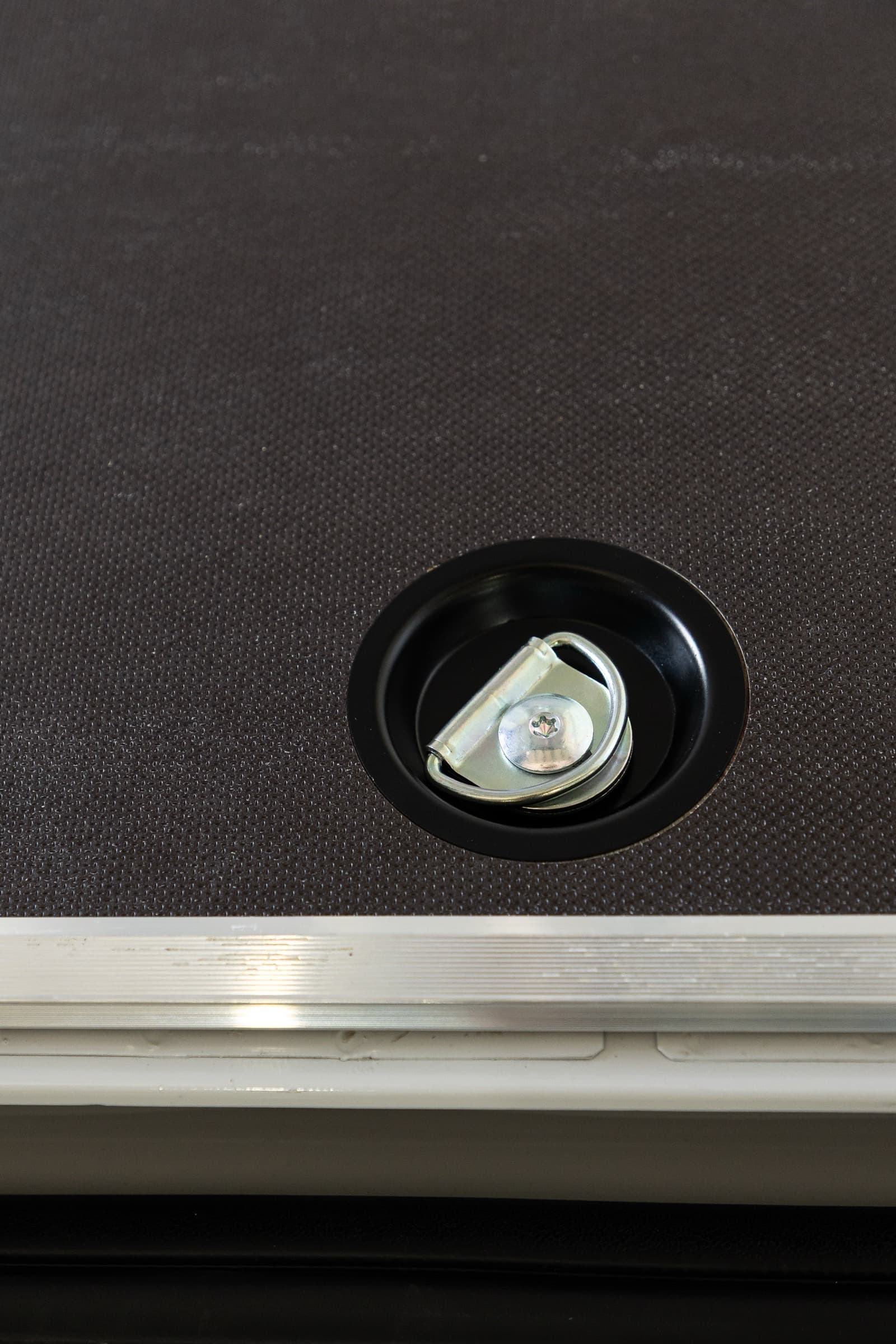 Recessed load-anchoring ring set into the anti-slip birch floor